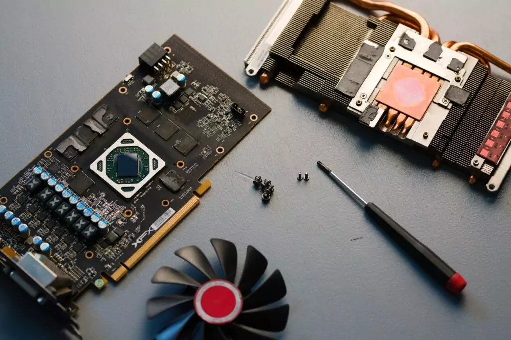 top view of disassembled graphics card xfx gpu amd fan screws screwdriver on a table