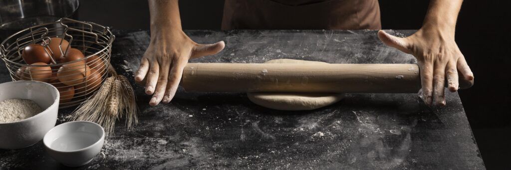 chef using rolling pin dough